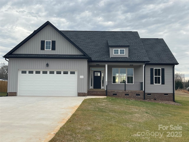 view of front facade with a porch, a garage, and a front lawn