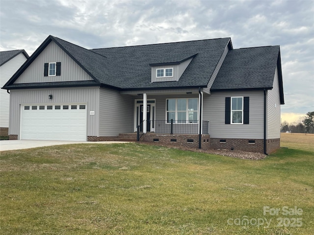 view of front of home with a garage, covered porch, and a front lawn