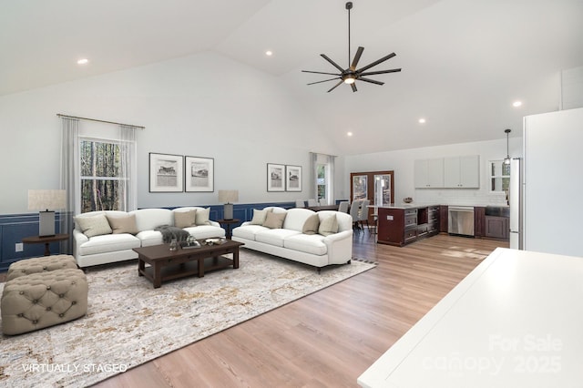 living room featuring light wood-style floors, recessed lighting, ceiling fan, and high vaulted ceiling