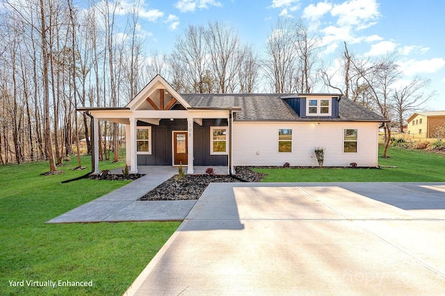 modern farmhouse style home with covered porch and a front lawn