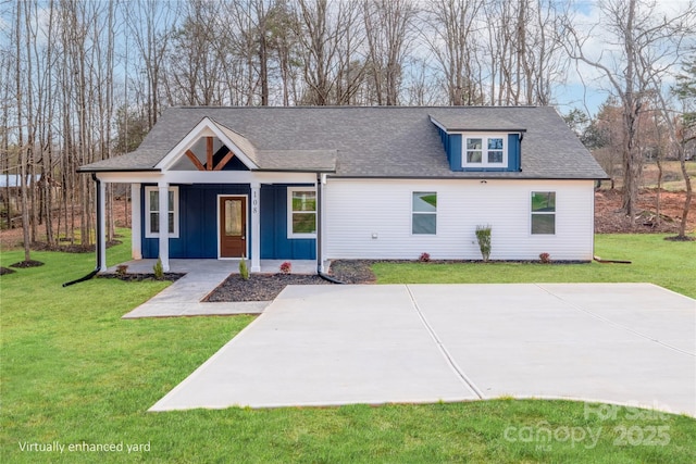 view of front of house with a shingled roof, a porch, board and batten siding, and a front yard