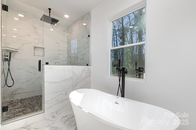 bathroom with marble finish floor, a soaking tub, a marble finish shower, and recessed lighting