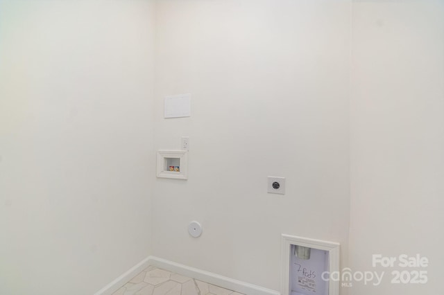 clothes washing area featuring washer hookup, hookup for an electric dryer, gas dryer hookup, laundry area, and baseboards