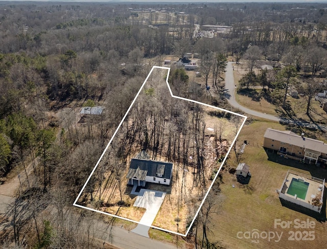 drone / aerial view with a view of trees and a rural view