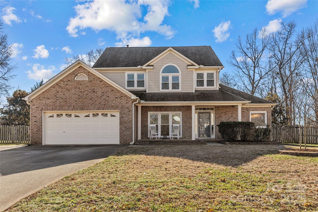 view of front of home featuring a garage and a front lawn