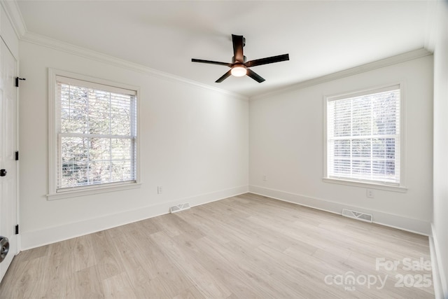 spare room featuring ceiling fan, a healthy amount of sunlight, and ornamental molding