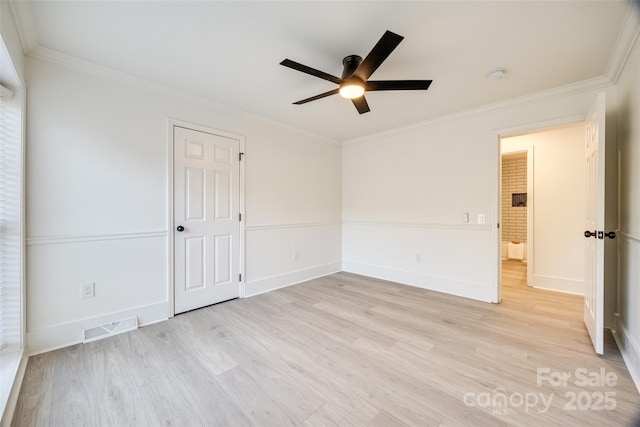 spare room featuring crown molding, ceiling fan, and light hardwood / wood-style floors