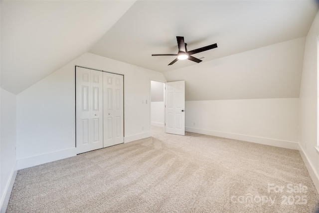 additional living space featuring carpet, ceiling fan, and vaulted ceiling