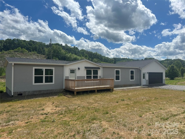 392 Burnsville School Rd, Burnsville, NC 28714 - view of front facade featuring a deck, a front lawn, and an attached garage