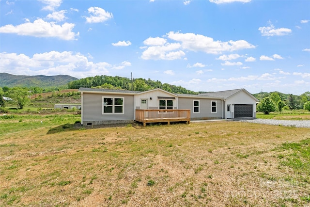392 Burnsville School Rd, Burnsville, NC 28714 - back of property with a deck with mountain view, gravel driveway, and an attached garage