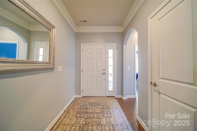 entryway with hardwood / wood-style flooring, crown molding, and a healthy amount of sunlight