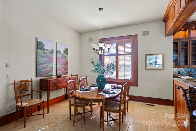 dining area featuring an inviting chandelier