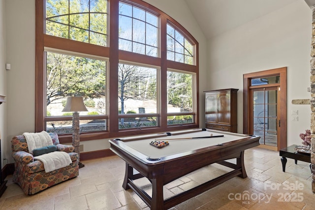 playroom with high vaulted ceiling and pool table