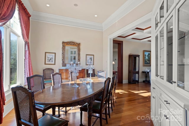 dining room with beam ceiling, wood-type flooring, ornamental molding, and coffered ceiling