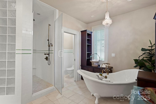 bathroom featuring toilet, separate shower and tub, and tile patterned floors