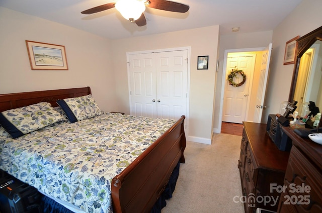 carpeted bedroom featuring ceiling fan and a closet