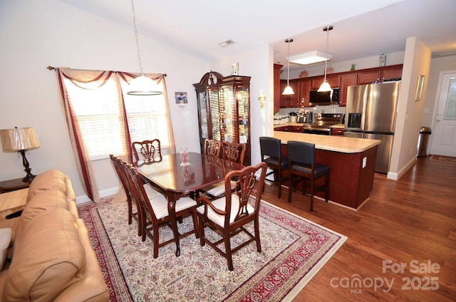 dining space featuring dark hardwood / wood-style floors