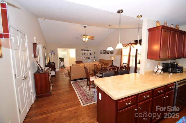 kitchen with ceiling fan, dark wood-type flooring, pendant lighting, lofted ceiling, and dishwashing machine