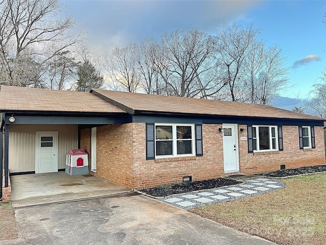 ranch-style home featuring a carport