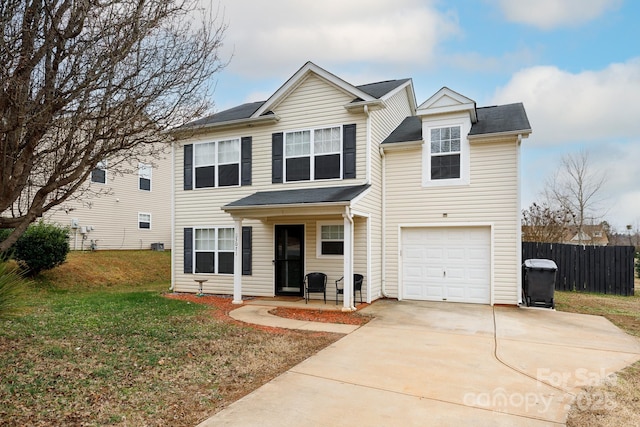 view of property with a garage and a front lawn