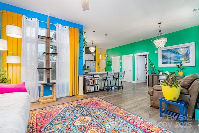 living room featuring hardwood / wood-style floors and a notable chandelier