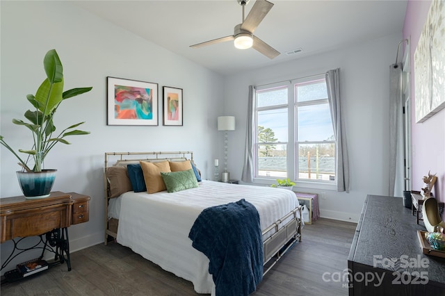 bedroom featuring dark wood-style flooring, a ceiling fan, visible vents, vaulted ceiling, and baseboards