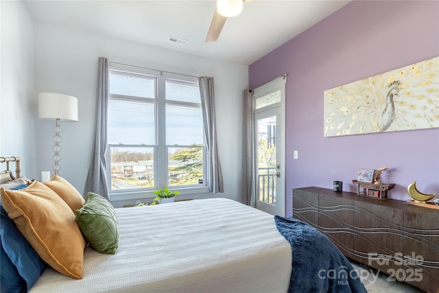 bedroom with access to exterior, visible vents, and ceiling fan