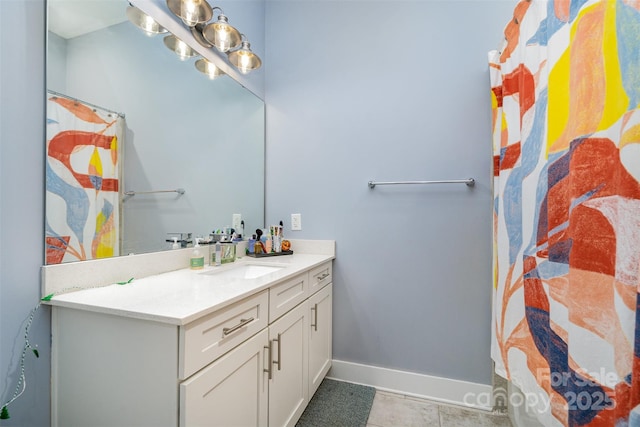 full bathroom with vanity and baseboards