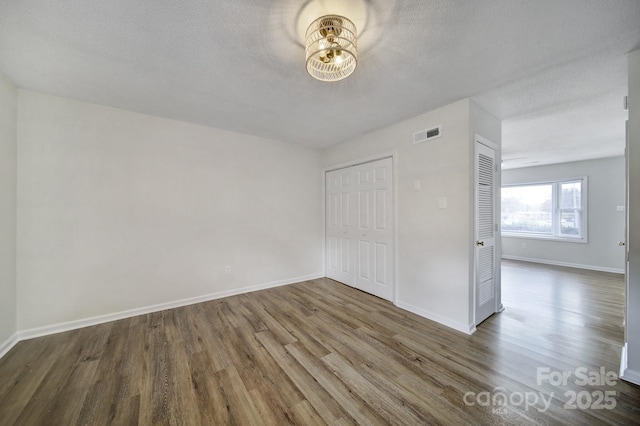 438 Stoneycreek Ln, Rock Hill, SC 29730 - unfurnished bedroom featuring a closet, hardwood / wood-style floors, and a textured ceiling