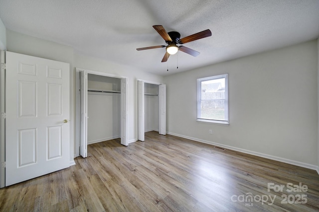 438 Stoneycreek Ln, Rock Hill, SC 29730 - unfurnished bedroom featuring ceiling fan, light hardwood / wood-style floors, a textured ceiling, and multiple closets