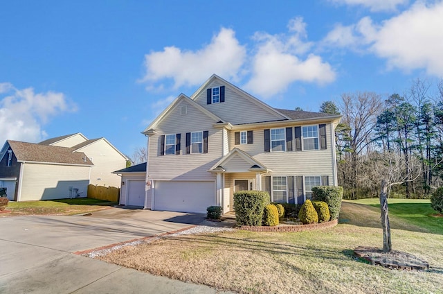 view of front property featuring a garage and a front lawn