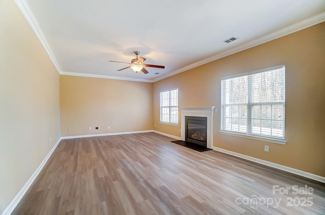 unfurnished living room featuring ceiling fan, light hardwood / wood-style floors, and crown molding