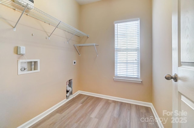 washroom with a healthy amount of sunlight, hardwood / wood-style floors, washer hookup, and hookup for an electric dryer