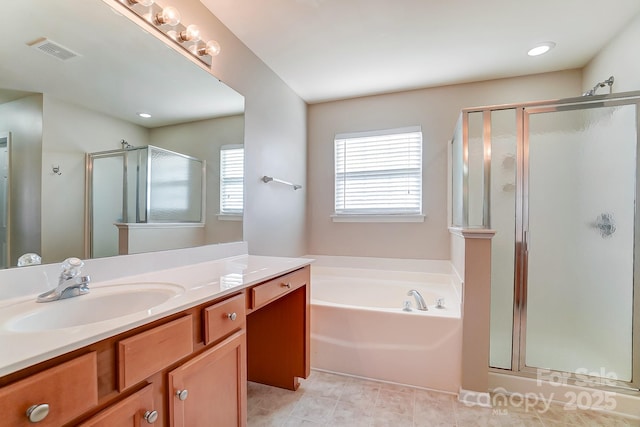 bathroom with tile patterned flooring, vanity, and independent shower and bath