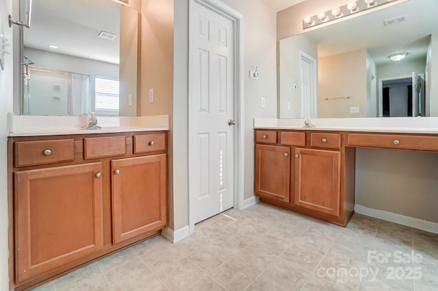 bathroom featuring vanity and a shower with shower door