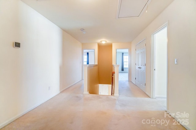 corridor featuring light colored carpet