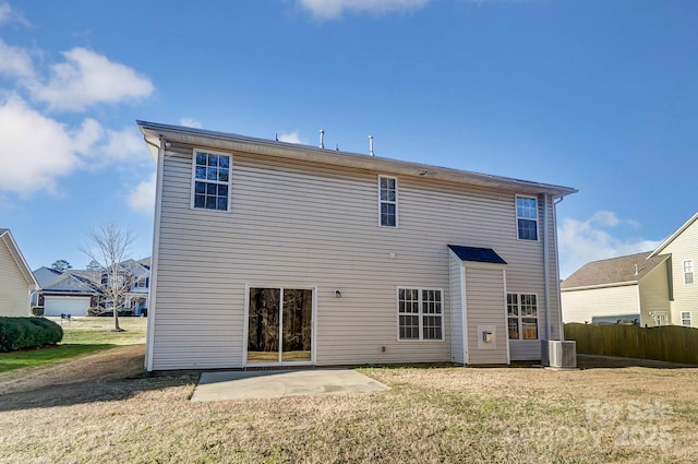 rear view of house featuring a lawn, a patio, and central AC