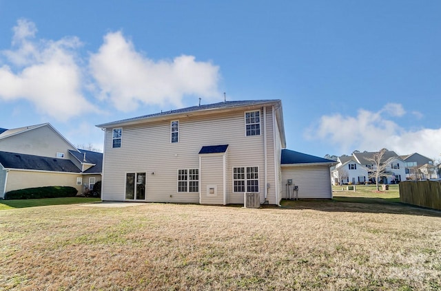 back of property featuring a lawn