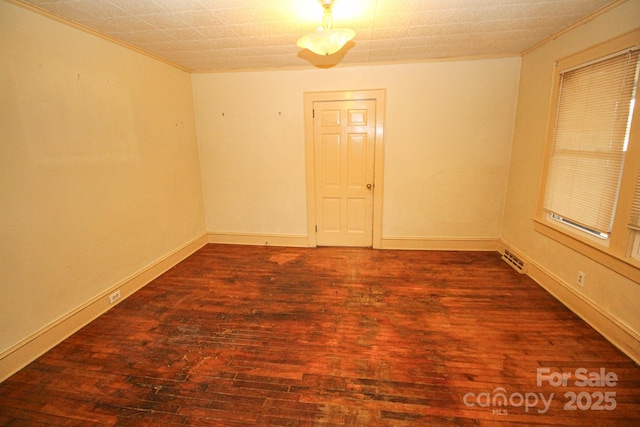 unfurnished room featuring dark hardwood / wood-style floors and ornamental molding