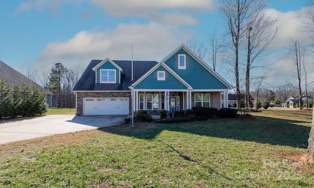 view of front of house featuring a porch, a front yard, and a garage