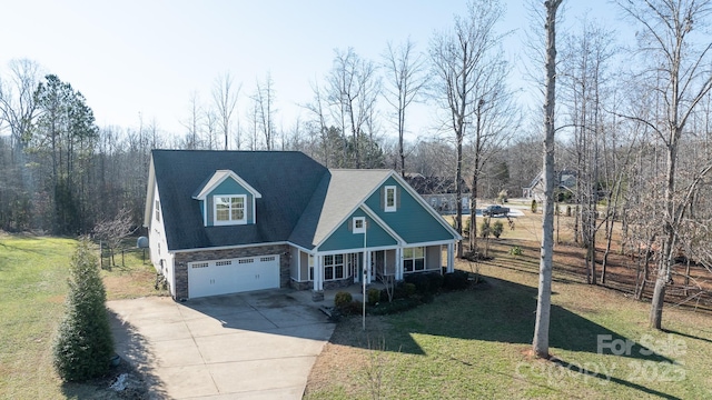 view of front facade featuring covered porch, a garage, and a front yard