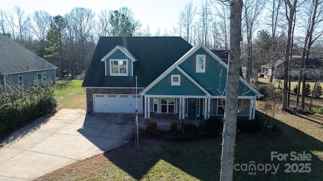 view of front of home featuring a front lawn, covered porch, and a garage