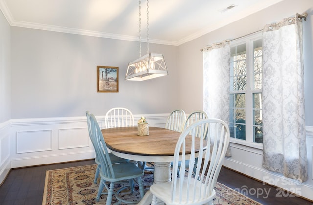 dining space with a chandelier, dark hardwood / wood-style flooring, and crown molding