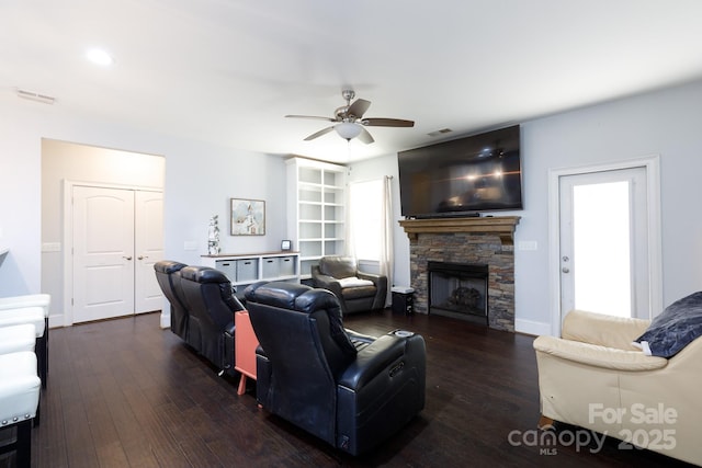 living room featuring a fireplace, dark hardwood / wood-style floors, and ceiling fan