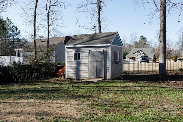 view of outdoor structure featuring a lawn