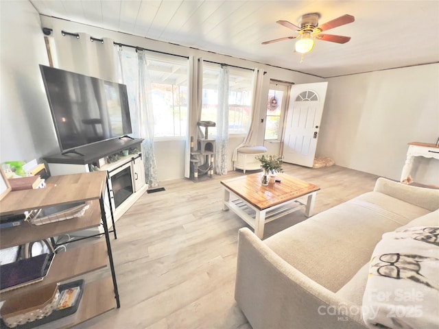 living room featuring wood ceiling, light hardwood / wood-style flooring, and ceiling fan