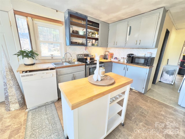 kitchen featuring sink, butcher block countertops, stainless steel electric range, dishwasher, and decorative backsplash