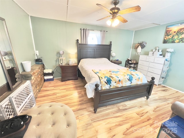 bedroom with hardwood / wood-style floors and ceiling fan