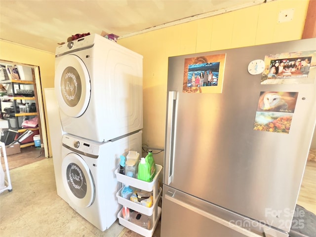 laundry room featuring stacked washer and clothes dryer