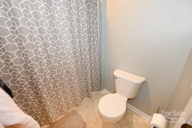 bathroom with tile patterned floors and toilet